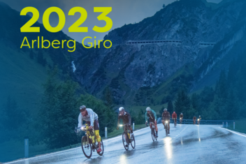 Four racing cyclists battle their way through the rain and mountainous landscape at the Arlberg Giro 2021. They are focussed and on the move. Female racing cyclist celebrates her victory with arms raised. She is wearing a red and white racing jersey.  ‘2023 Arlberg Giro’ is written in yellow/green at the top left of the picture.