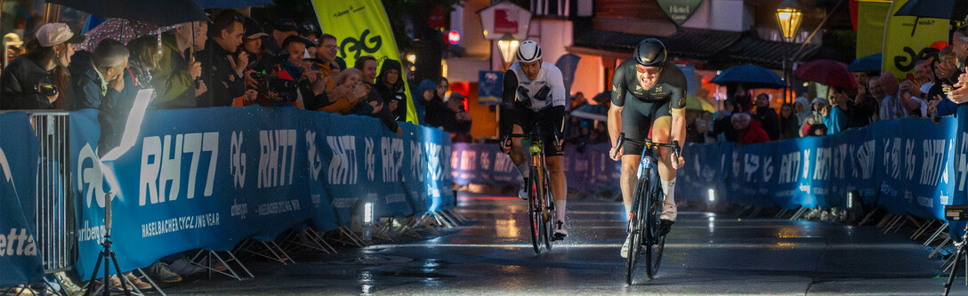 Two athletes race through the finish area at the St. Anton Night Sprint